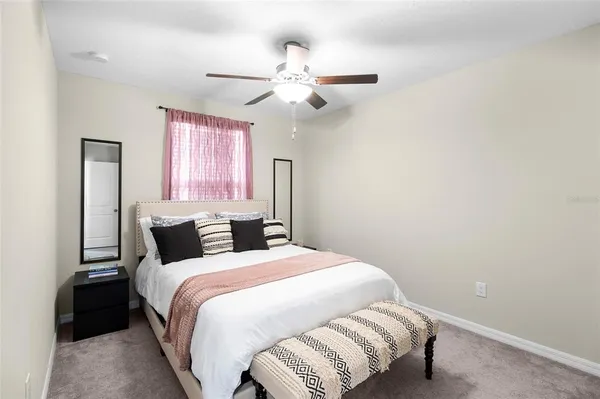 a bedroom with a bed and window