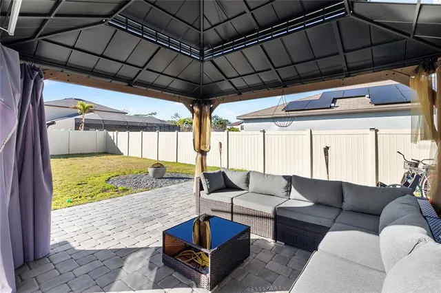 a outdoor living space with furniture and a black umbrella