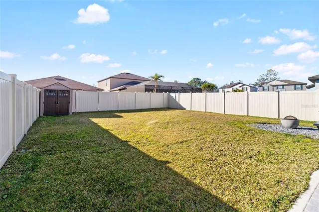 a swimming pool with trees in front of it