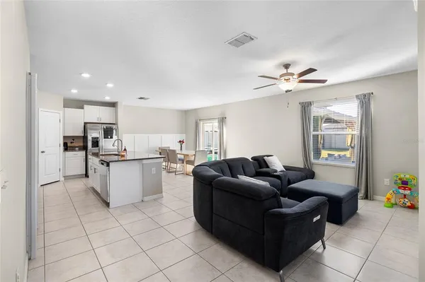 a living room with furniture and kitchen view