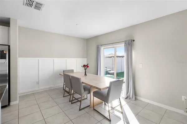 a view of a dining room with furniture and a window