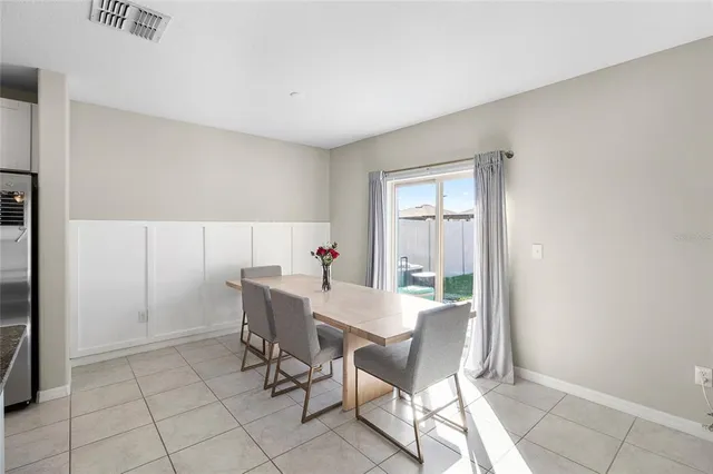 a view of a dining room with furniture and a window