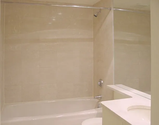 a bathroom with a shower and a bath tub