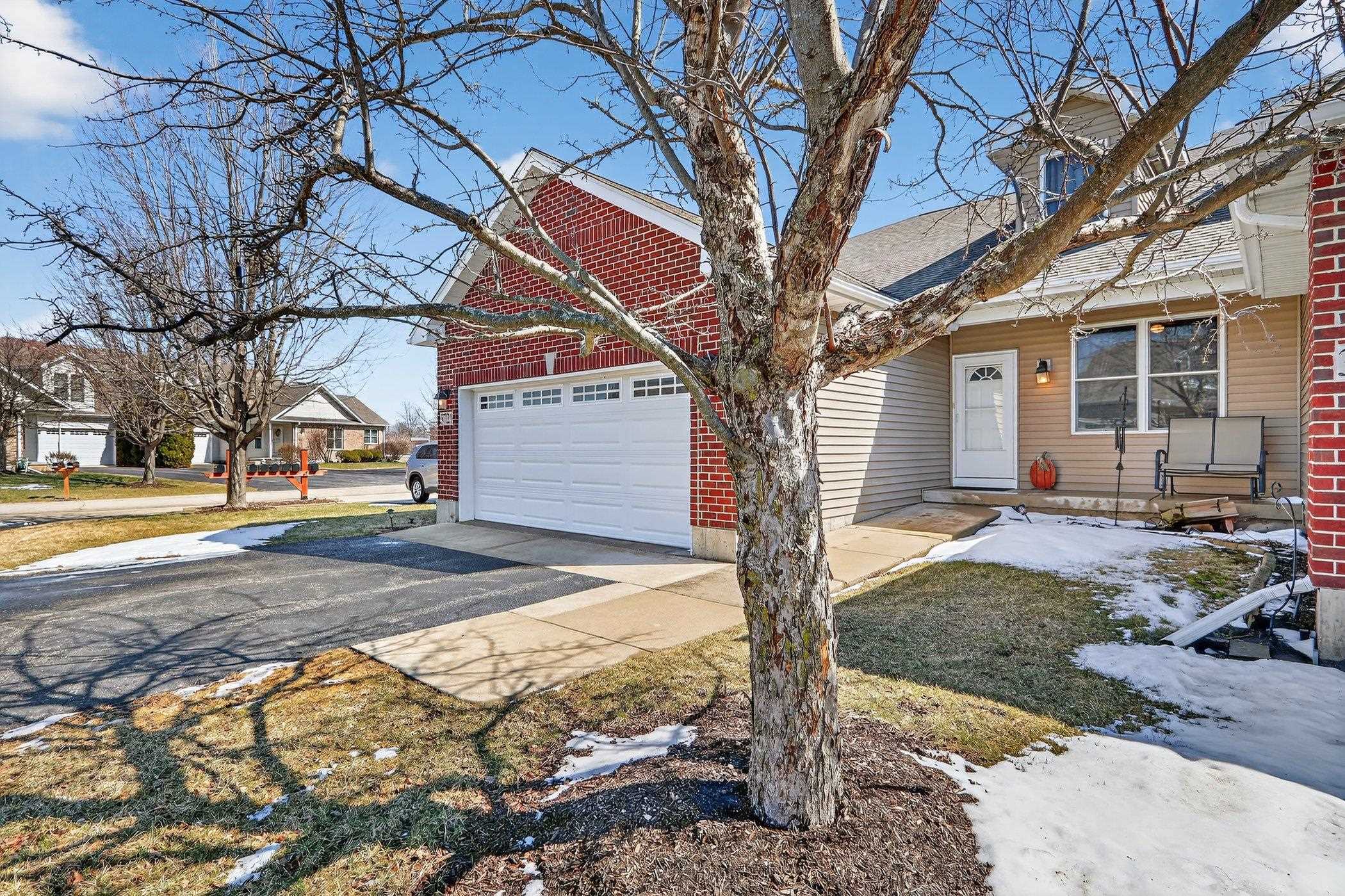 3721 Green Tree Lane DeKalb, IL 60115 - Photo 2 of 20 a front view of a house with a yard and large tree