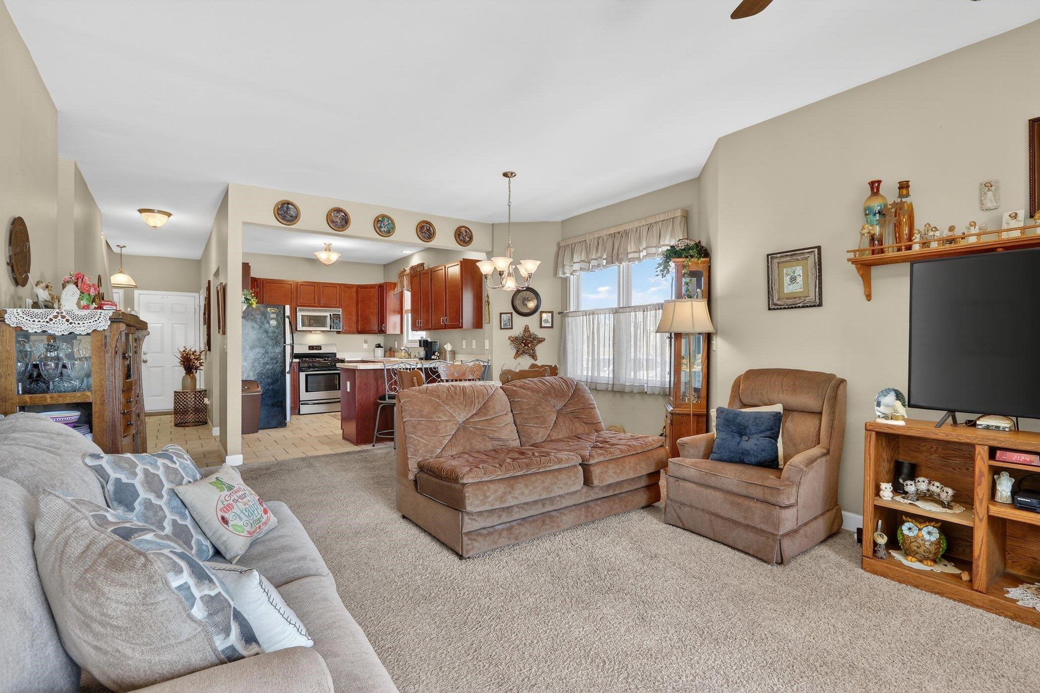 3721 Green Tree Lane DeKalb, IL 60115 - Photo 5 of 20 a living room with furniture and a flat screen tv