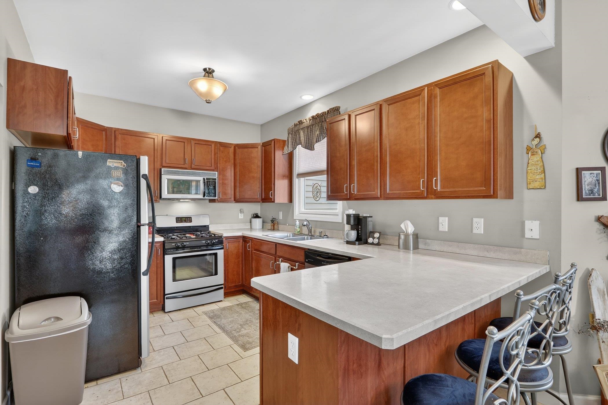 3721 Green Tree Lane DeKalb, IL 60115 - Photo 10 of 20 a kitchen with stainless steel appliances granite countertop a sink stove and refrigerator