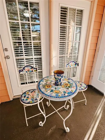 a living room with furniture a dining table and a window