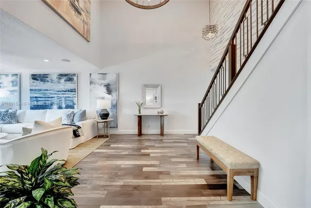 a view of entryway and hall with wooden floor