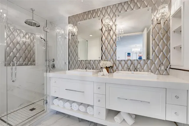 a bathroom with a double vanity sink mirror and shower