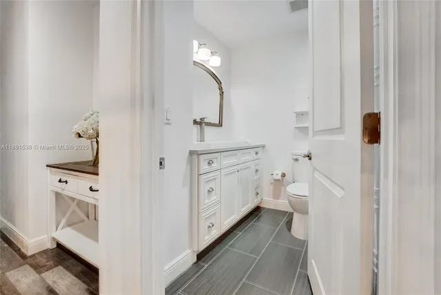 a bathroom with a toilet sink and mirror