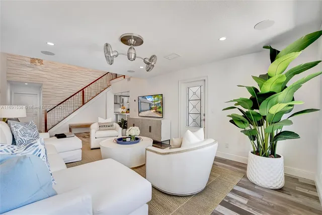 a living room with furniture a potted plant and a potted plant