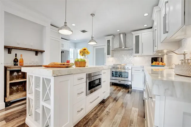 a kitchen with stainless steel appliances a stove a sink and a refrigerator