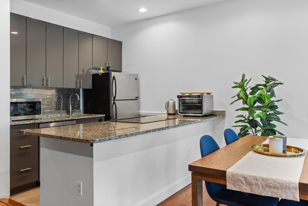 113 Chandler Street, Unit 1 Boston, MA 02116 - Photo 4 of 10 a kitchen with a table and chairs in it