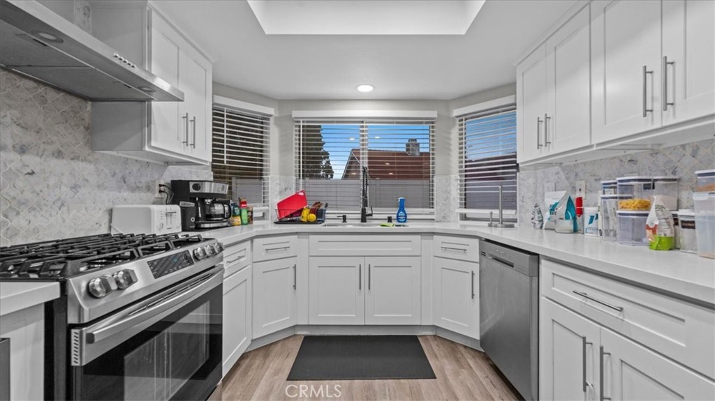 7550 Periwinkle Drive Fontana, CA 92336 - Photo 12 of 25 a kitchen with a sink stove and cabinets
