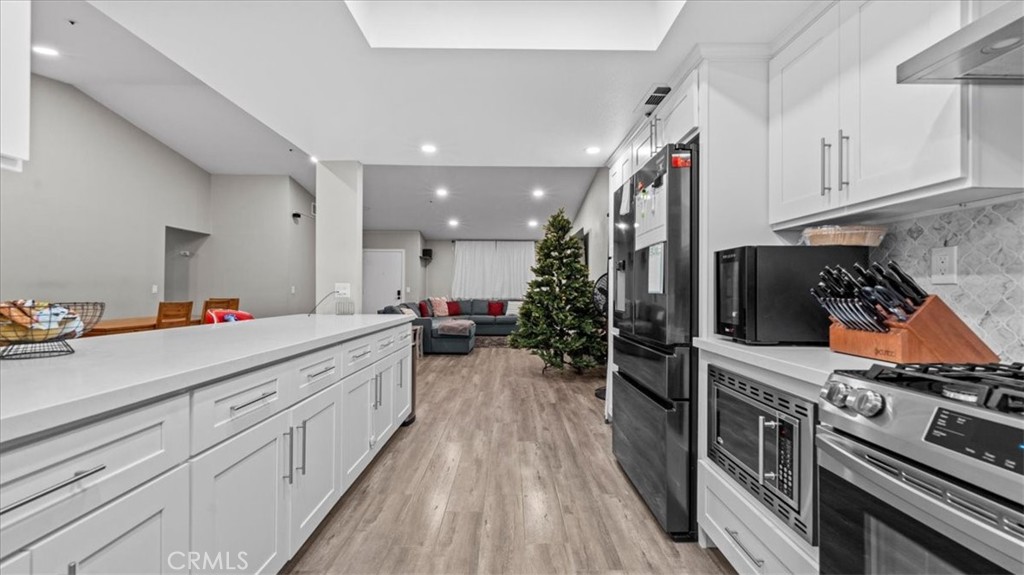 7550 Periwinkle Drive Fontana, CA 92336 - Photo 13 of 25 a kitchen with stove a sink and refrigerator