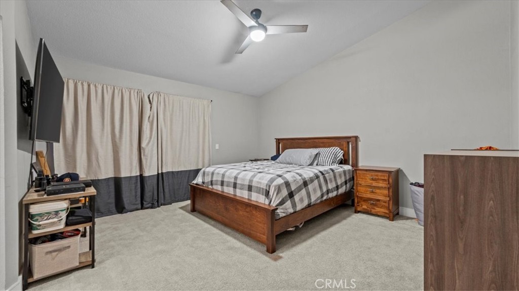 7550 Periwinkle Drive Fontana, CA 92336 - Photo 14 of 25 a bedroom with a bed and a closet