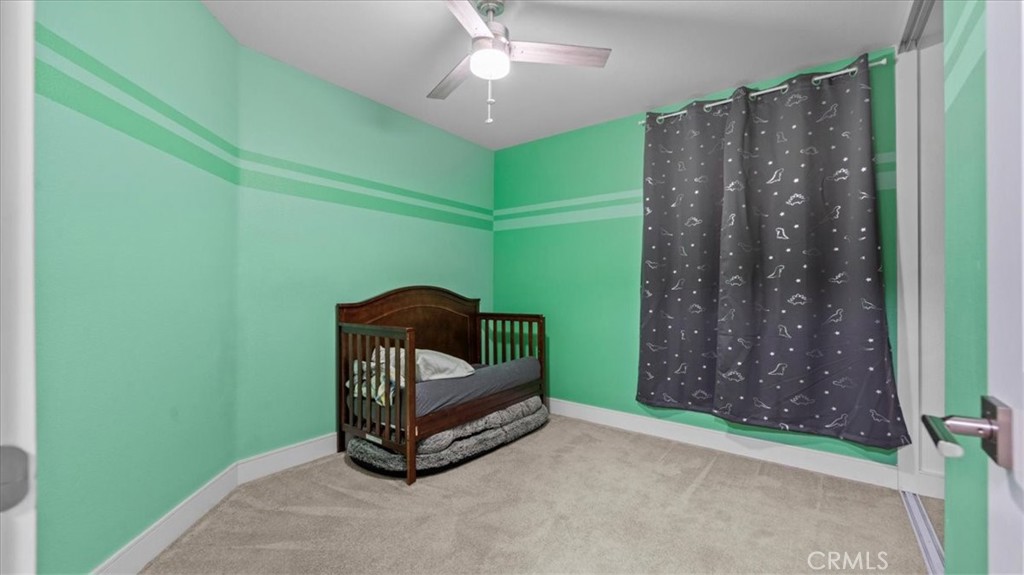7550 Periwinkle Drive Fontana, CA 92336 - Photo 16 of 25 a living room with furniture and a chandelier