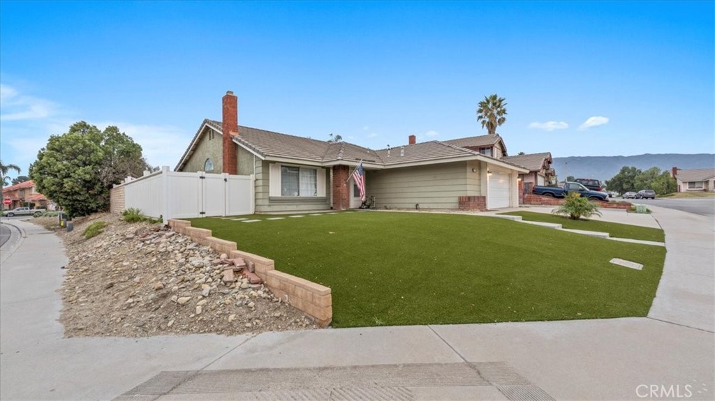 7550 Periwinkle Drive Fontana, CA 92336 - Photo 4 of 25 a front view of a house with a garden