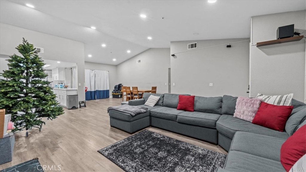 7550 Periwinkle Drive Fontana, CA 92336 - Photo 7 of 25 a living room with furniture plant and a rug