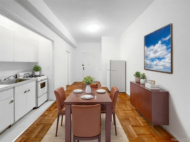 a view of a dining room with furniture a rug and wooden floor