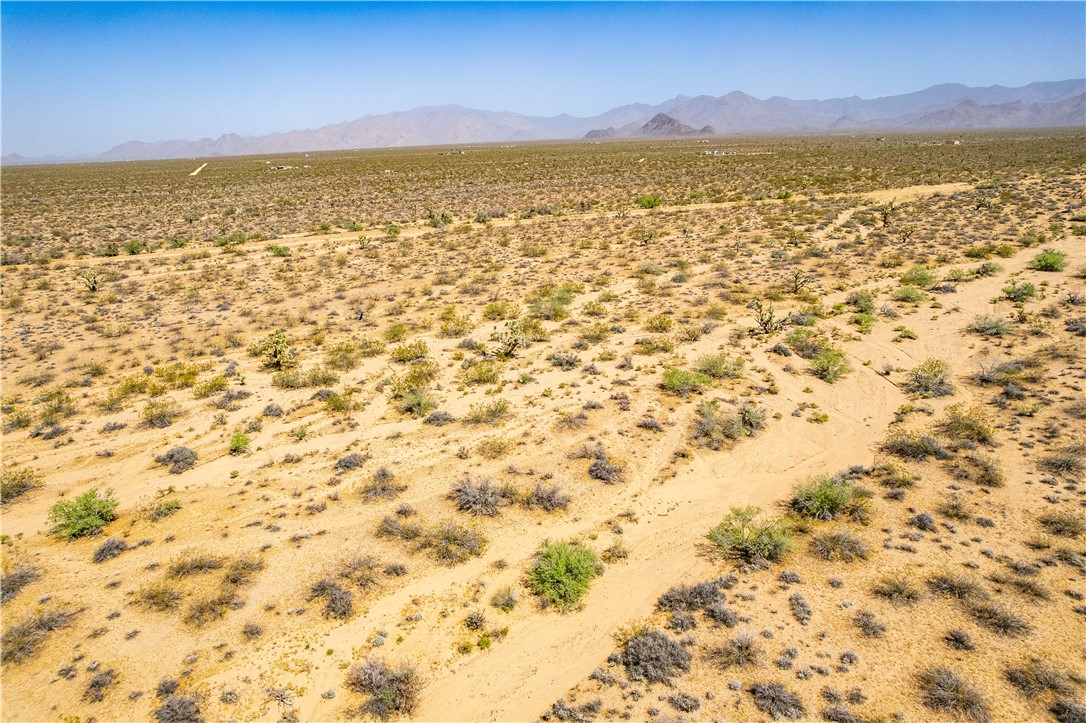 0 East Arroyo Road Yucca, AZ 86438 - Photo 15 of 25 Expansive desert landscape featuring natural brush and distant mountains under a clear sky