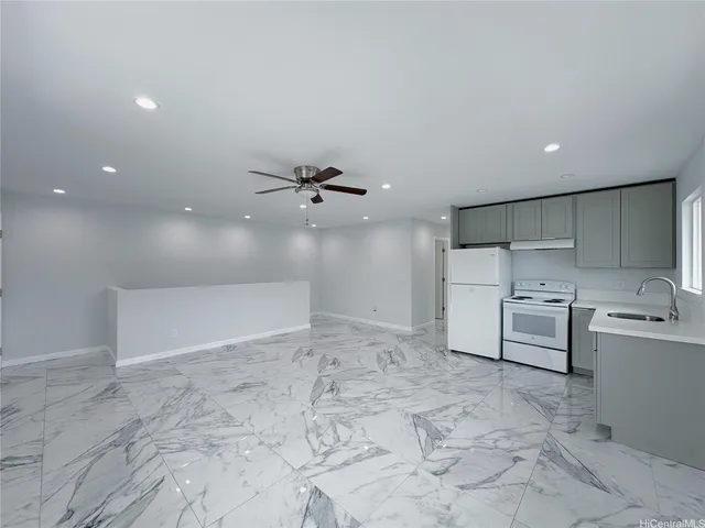 a kitchen with a sink white stove refrigerator and a window
