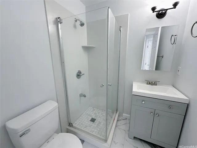 a view of a big room with wooden floor and a ceiling fan