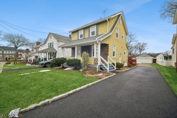 a front view of a house with a yard and porch