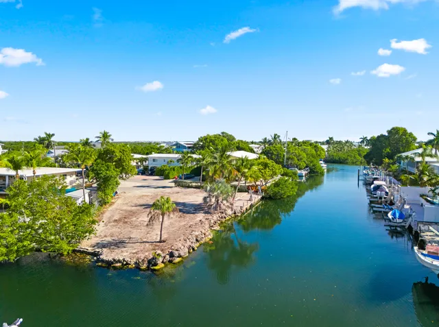 a view of a lake with lawn chairs