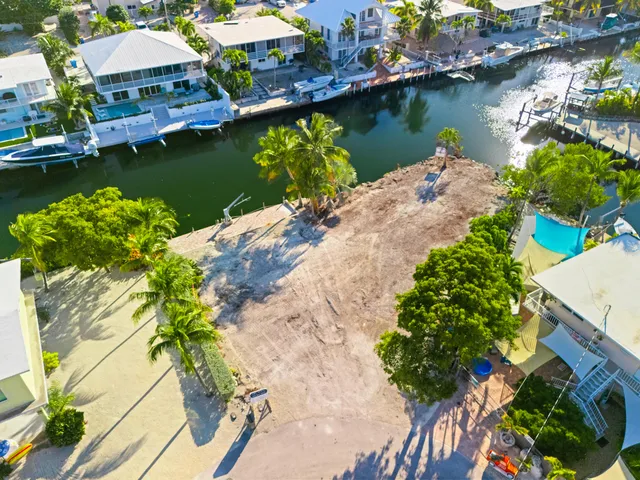 an aerial view of a house with a yard swimming pool and outdoor seating