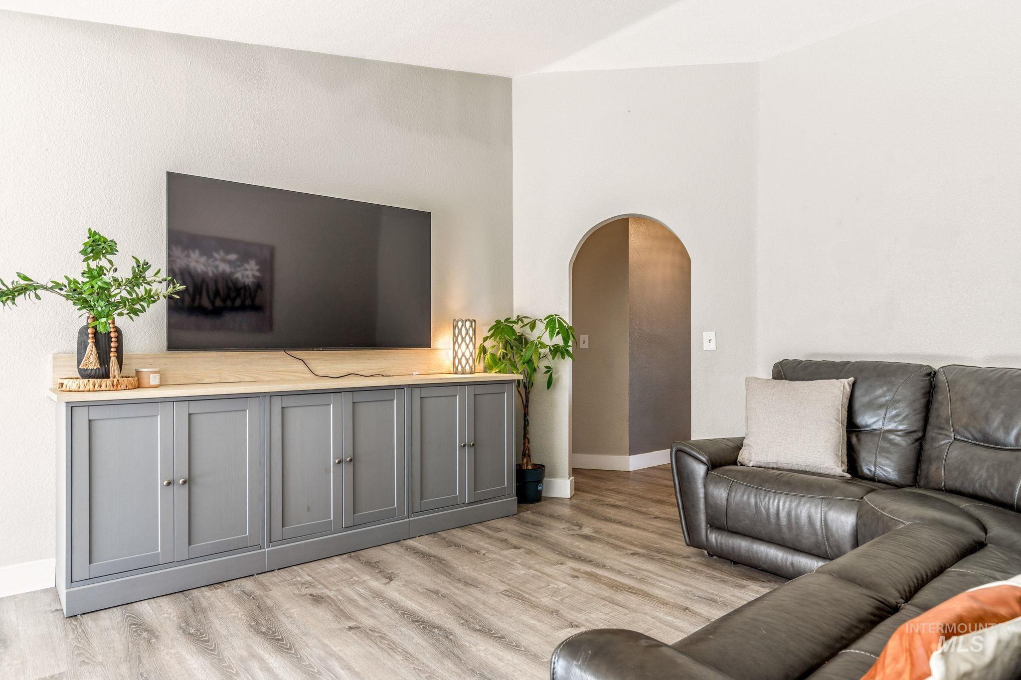 3209 Whitman Drive Boise, ID 83716 - Photo 12 of 45 Living room featuring arched walkways and light wood-style floors