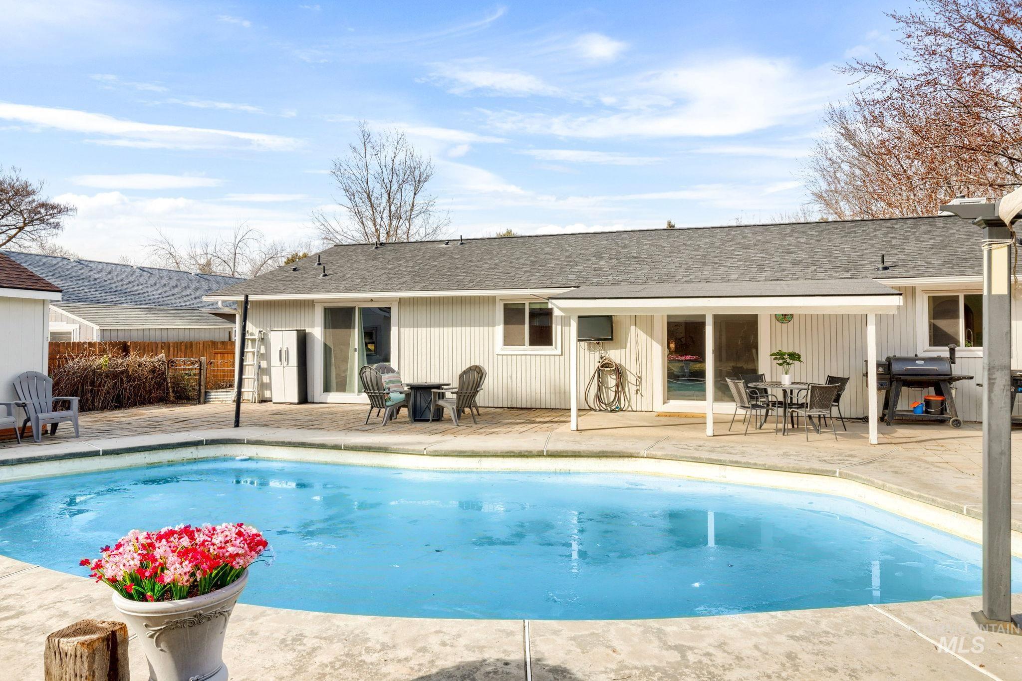 3209 Whitman Drive Boise, ID 83716 - Photo 2 of 45 Back of house with a shingled roof, a patio area, and outdoor dining space