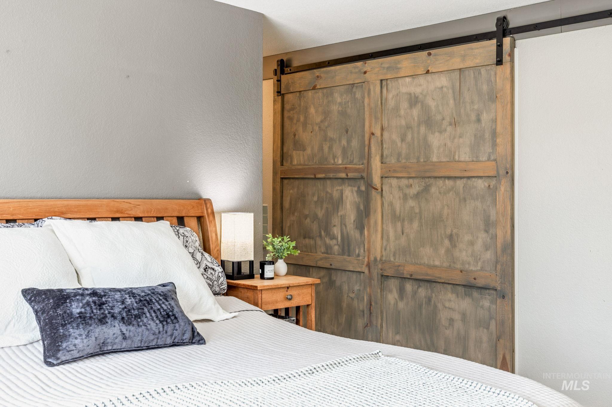 3209 Whitman Drive Boise, ID 83716 - Photo 22 of 45 Bedroom featuring a barn door, a textured wall, and a closet