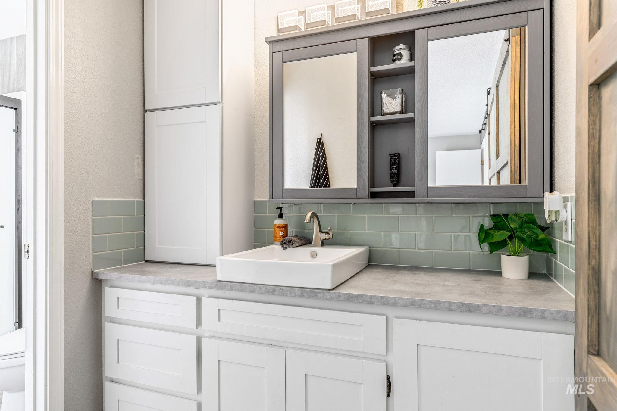 3209 Whitman Drive Boise, ID 83716 - Photo 23 of 45 Bathroom with vanity, tasteful backsplash, and a textured wall