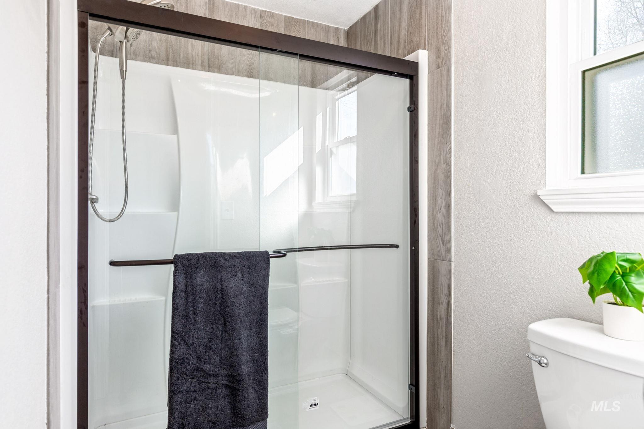 3209 Whitman Drive Boise, ID 83716 - Photo 24 of 45 Bathroom featuring a textured wall and a stall shower