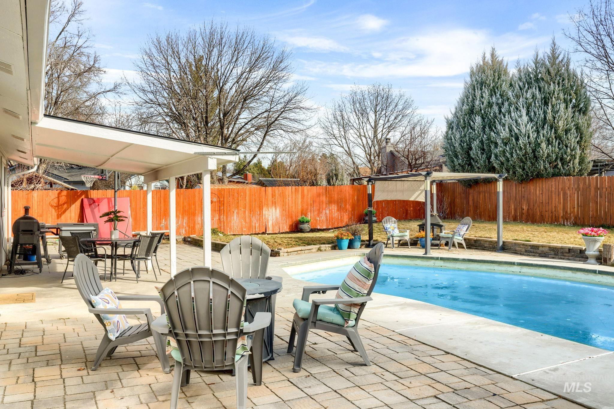 3209 Whitman Drive Boise, ID 83716 - Photo 32 of 45 View of swimming pool featuring outdoor dining area, patio surround, a fenced backyard, and an outdoor fire pit