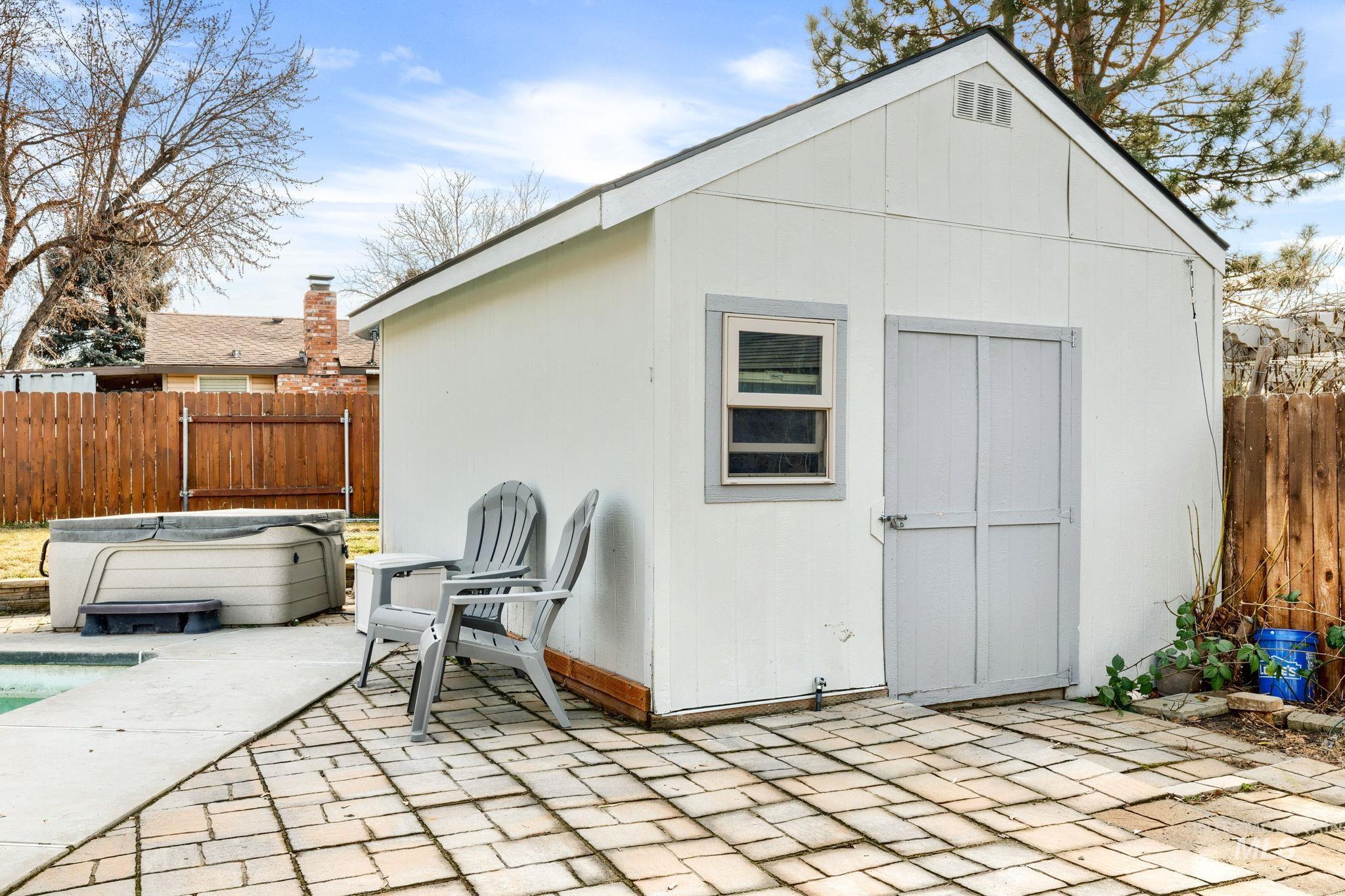 3209 Whitman Drive Boise, ID 83716 - Photo 38 of 45 View of shed featuring a fenced backyard and a hot tub