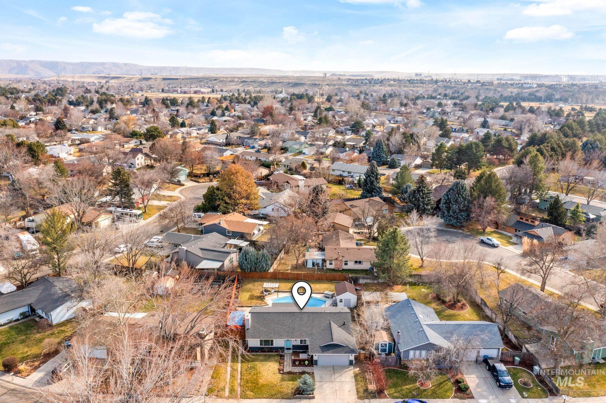 3209 Whitman Drive Boise, ID 83716 - Photo 39 of 45 Aerial view of property and surrounding area featuring nearby suburban area and a mountainous background