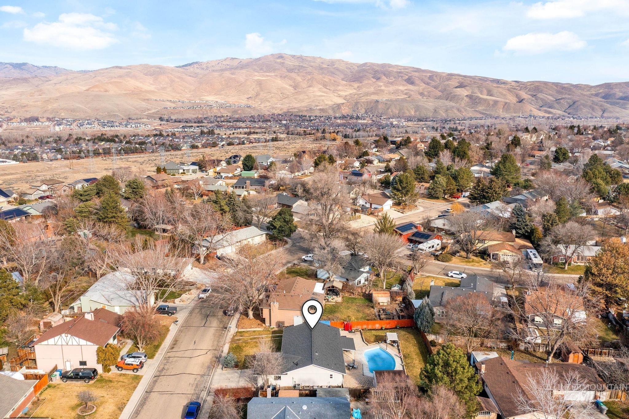 3209 Whitman Drive Boise, ID 83716 - Photo 42 of 45 Aerial view of property's location featuring nearby suburban area and a mountain backdrop