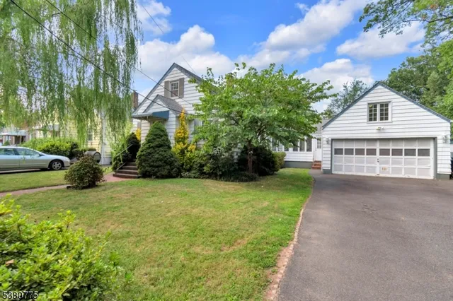 a view of a house with a yard and sitting area