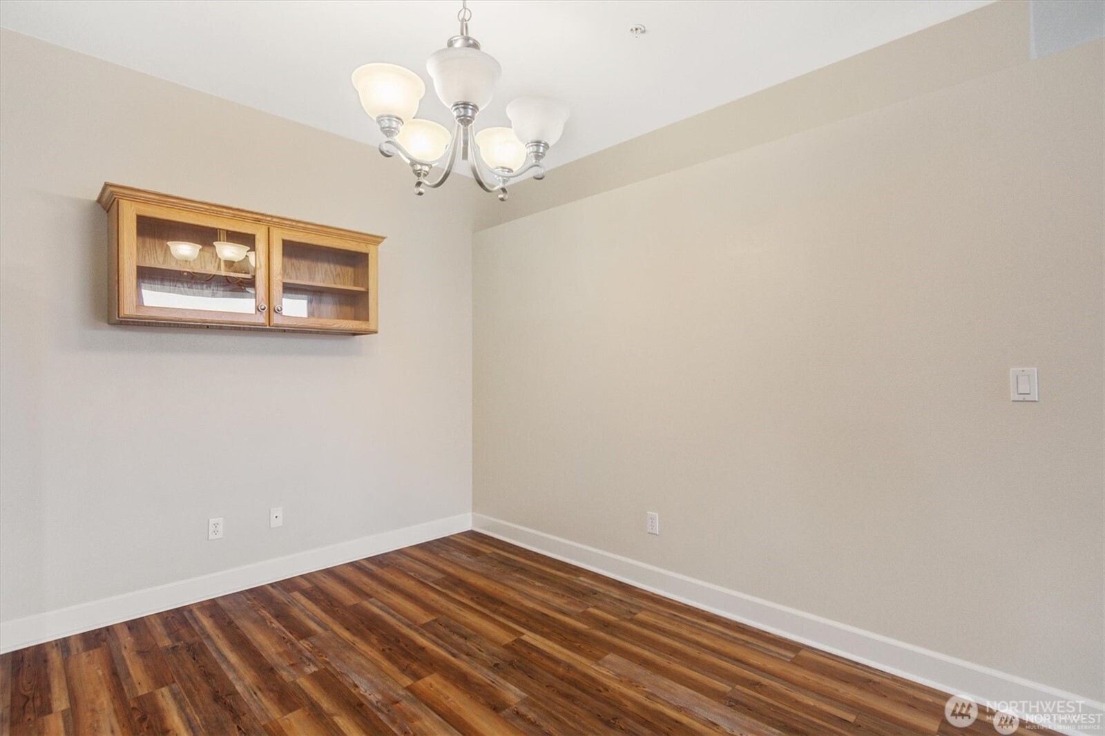 1548 River Road, Unit 209 Longview, WA 98632 - Photo 12 of 24 a view of a room with wooden floor and a chandelier