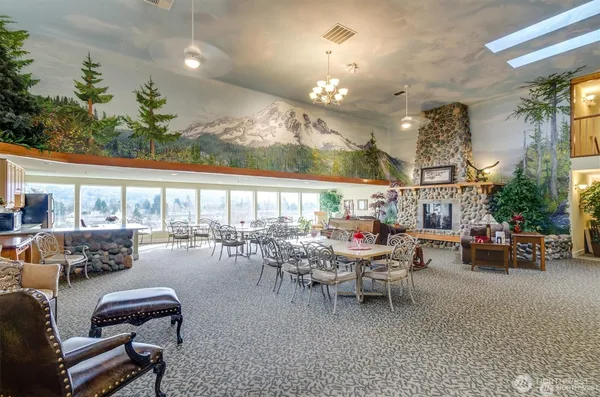 a room with lots of furniture a chandelier and a large window