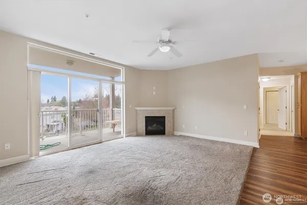 a view of a livingroom with a fireplace wooden floor and chandelier