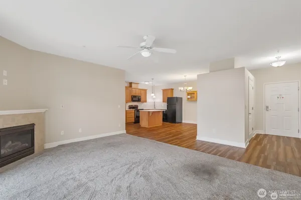 a view of a livingroom with furniture and a kitchen