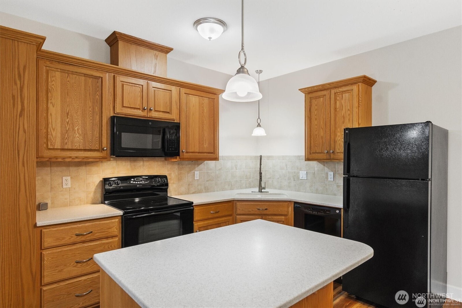 1548 River Road, Unit 209 Longview, WA 98632 - Photo 9 of 24 a kitchen with stainless steel appliances a stove a refrigerator a sink a stove and white cabinets