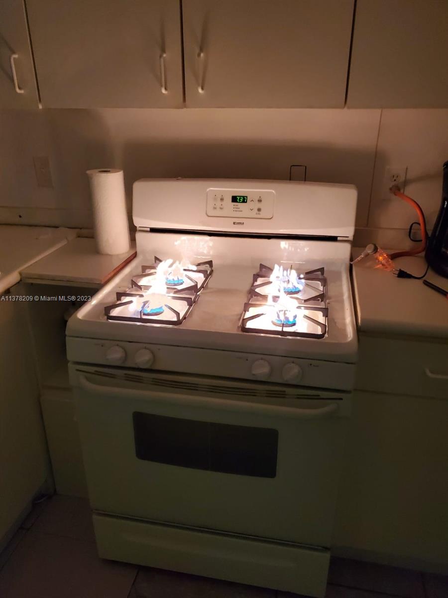 13101 Southwest 14th Street, Unit 1 Miami, FL 33184 - Photo 2 of 10 a stove top oven sitting inside of a kitchen