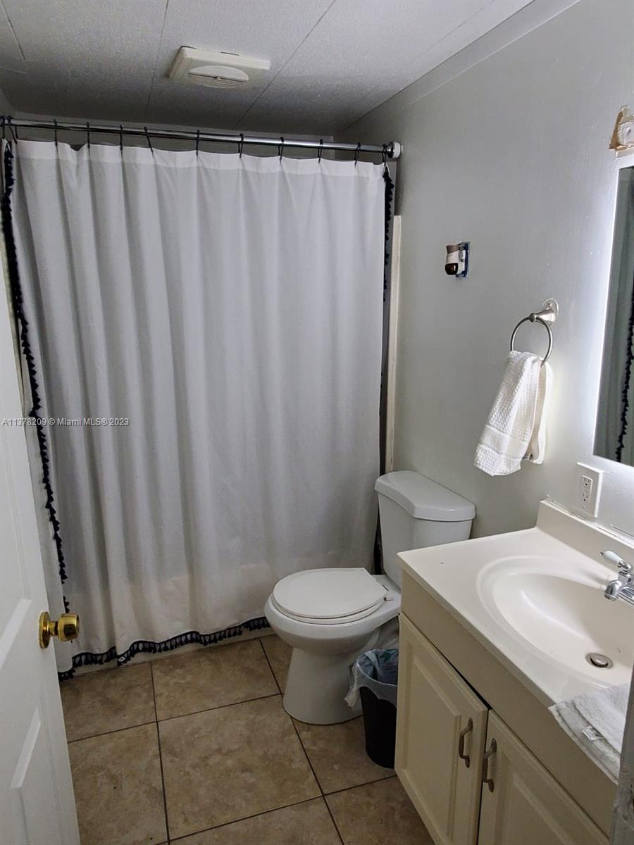 13101 Southwest 14th Street, Unit 1 Miami, FL 33184 - Photo 10 of 10 a bathroom with a sink toilet and shower