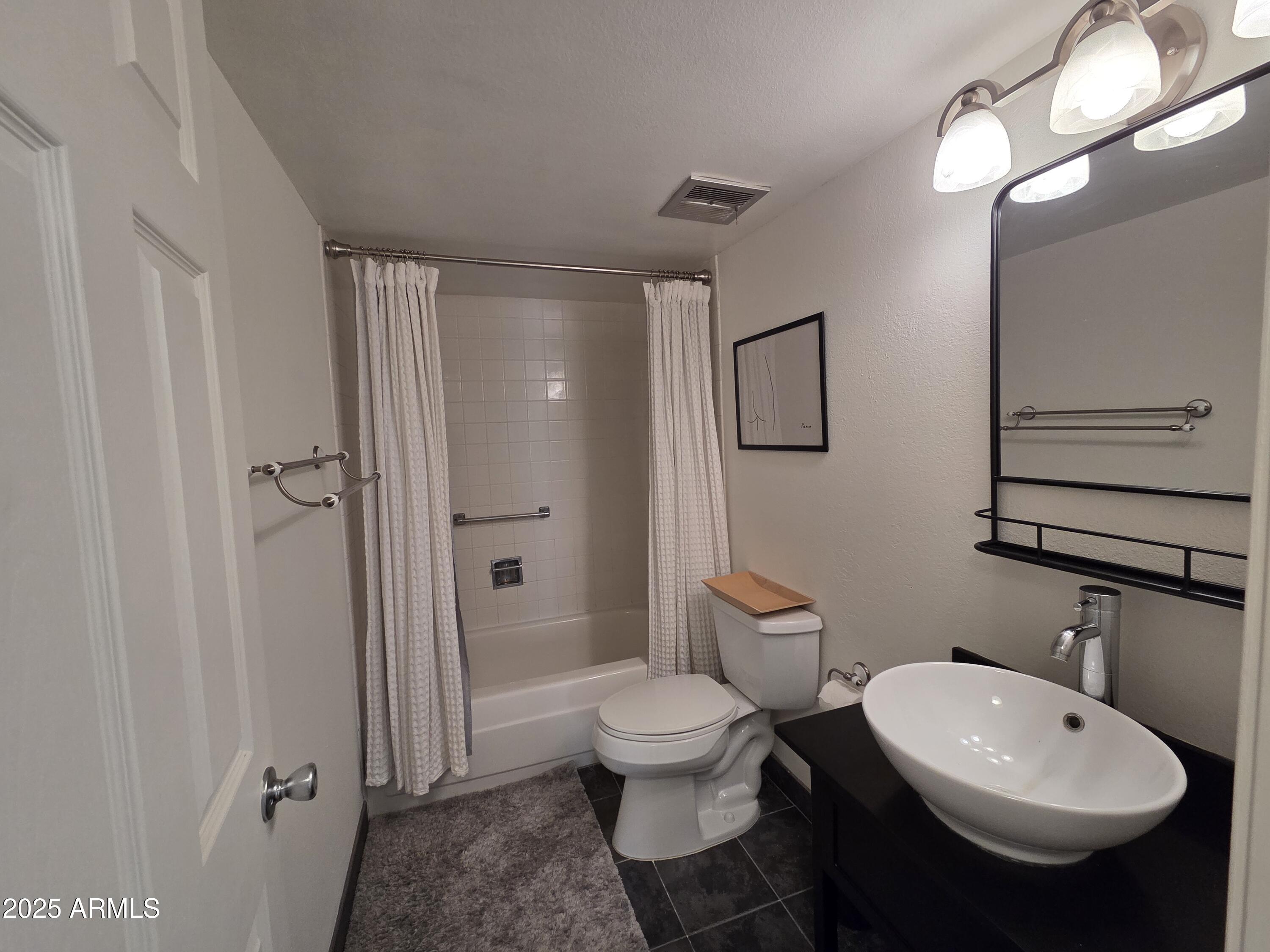 7920 East Camelback Road, Unit 408 Scottsdale, AZ 85251 - Photo 11 of 18 a bathroom with a toilet sink and shower