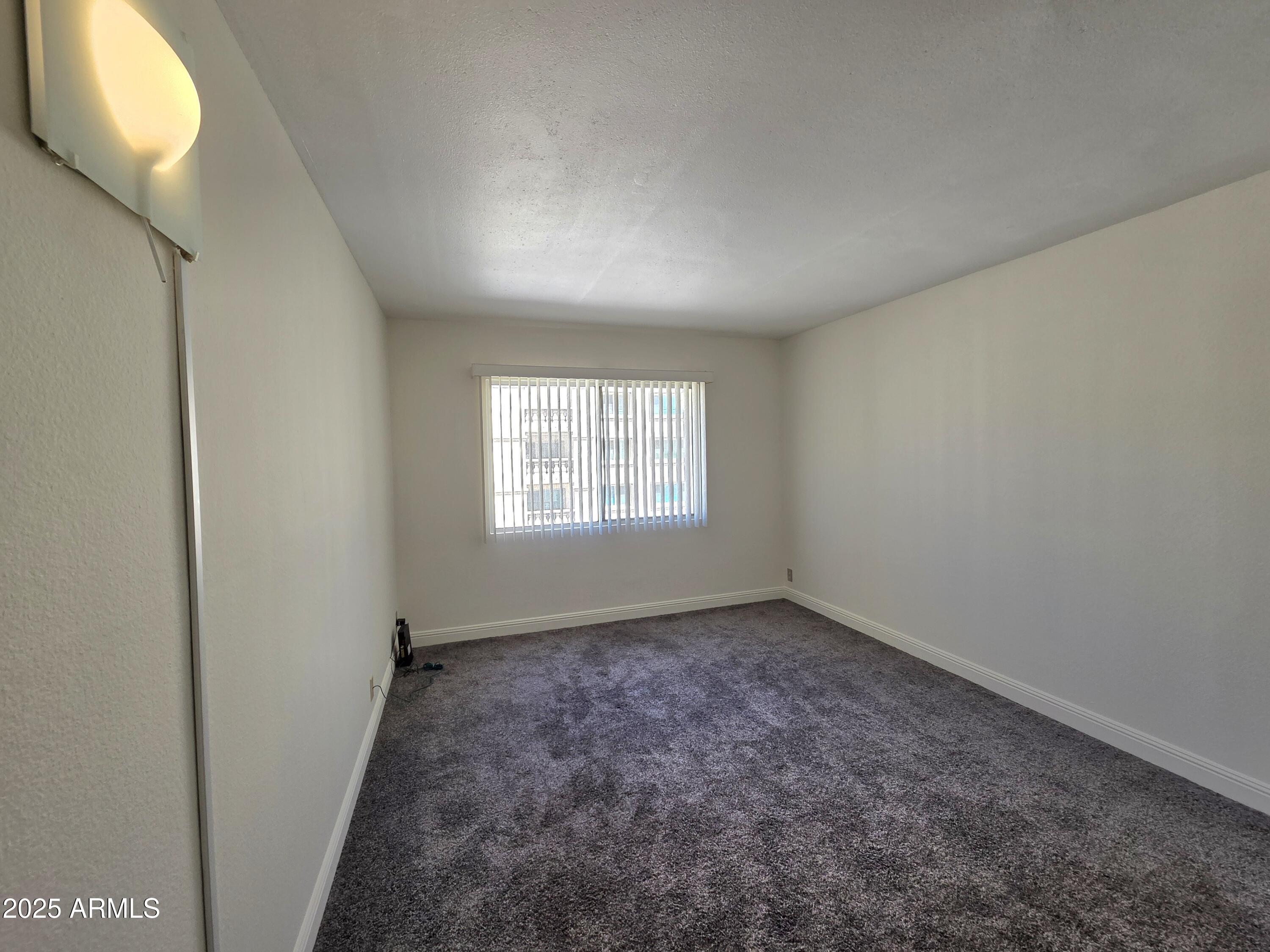 7920 East Camelback Road, Unit 408 Scottsdale, AZ 85251 - Photo 12 of 18 an empty room with windows