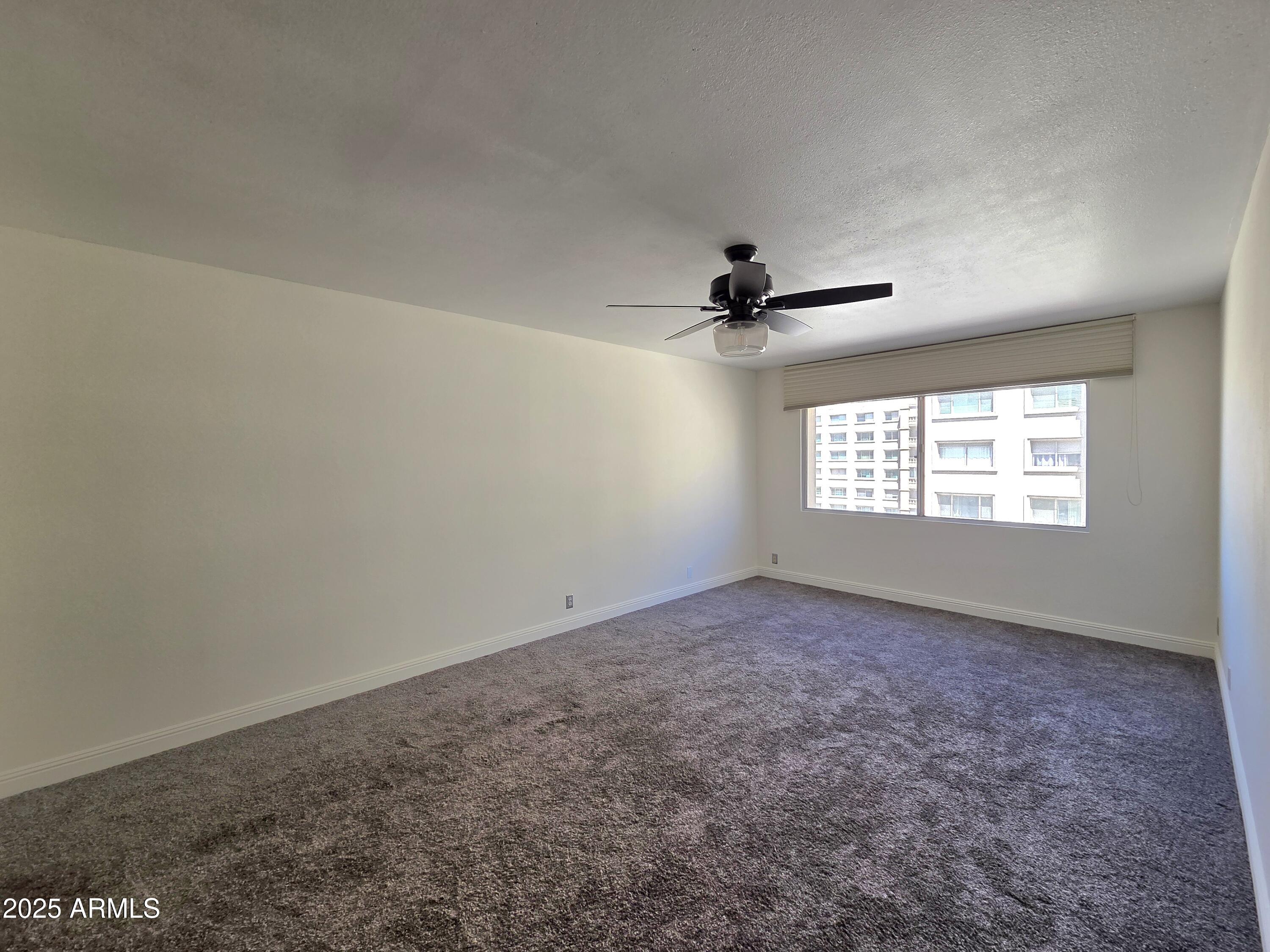 7920 East Camelback Road, Unit 408 Scottsdale, AZ 85251 - Photo 14 of 18 an empty room with windows